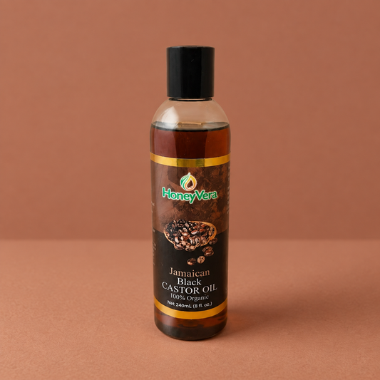 100% Jamaican Black Castor Oil on a warm brown background